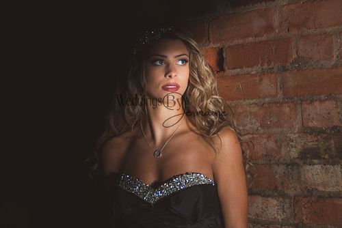 Close-up of a model in a black wedding dress from Bridal Re-Loved Leicester, with half her face in shadow, photographed by Weddings by Jermaine, with hair and makeup by Justaboutweddingshair and beauty, and accessories by Sydney Grace Bridal