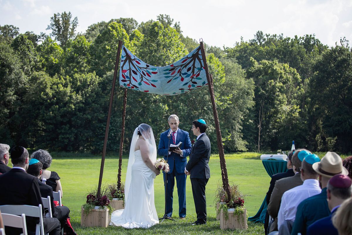 Jewish couple getting married under the chuppah