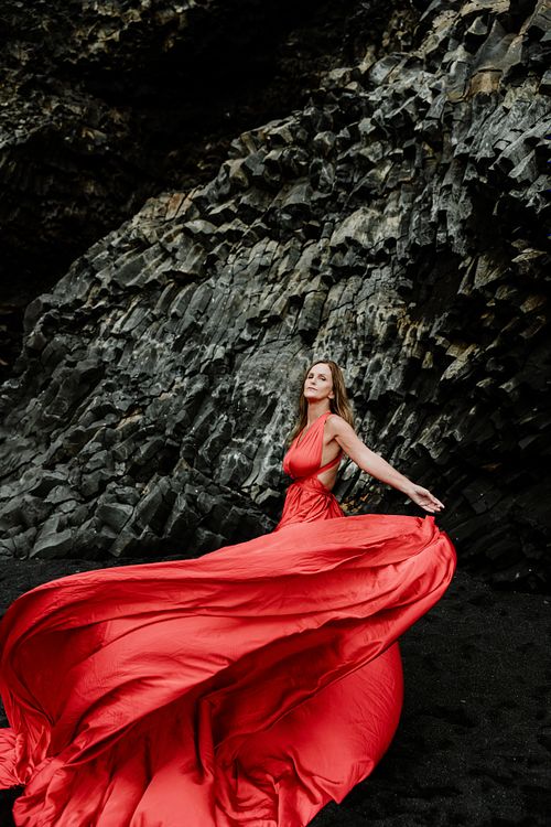 Solo female portrait with flowing dress at Reynisfjara in Iceland