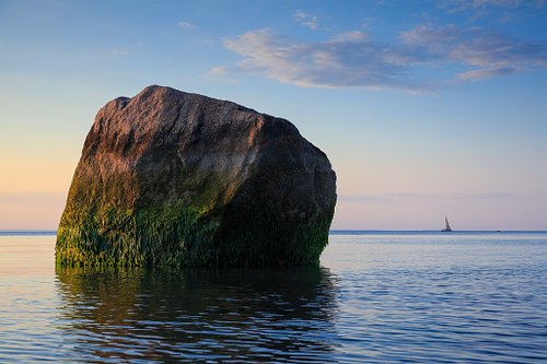 Potter's Rock and sailboat at Landing Beach.
