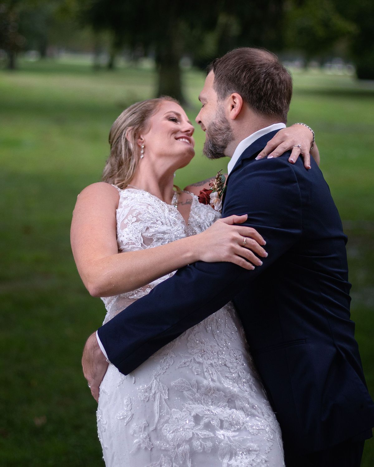 groom tipping his bride on the front porch at ross mansion while it is raining