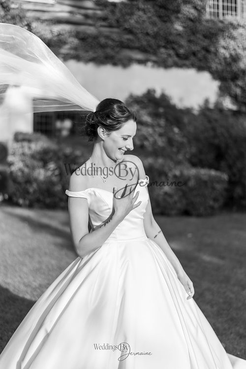 Wedding by Jermaine – black and white portrait of the bride alone on the venue grounds