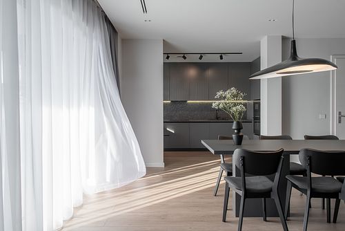 Mood photograph of living room with curtain gently blowing in the wind – Columna project