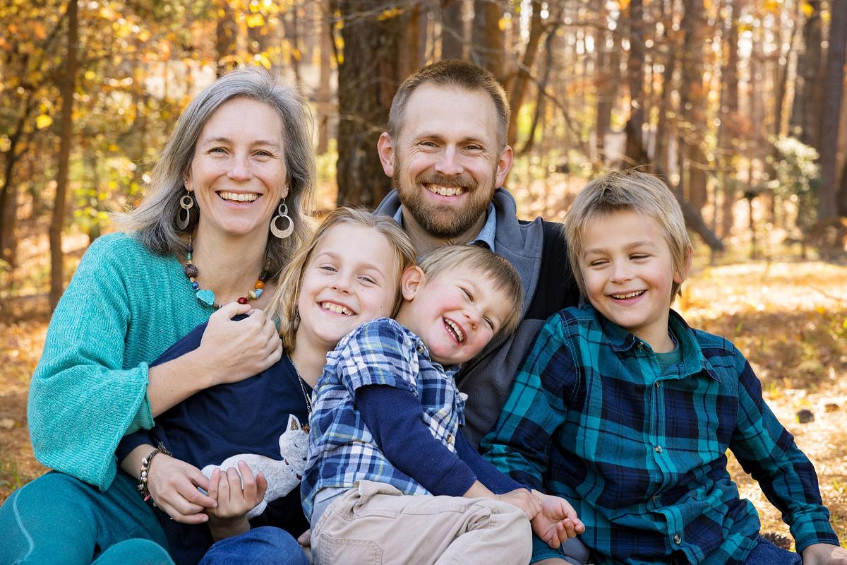 A family posing for a photograph at Golden Hour at Dr. Martin Luther King Jr. Park in Carrboro, NC